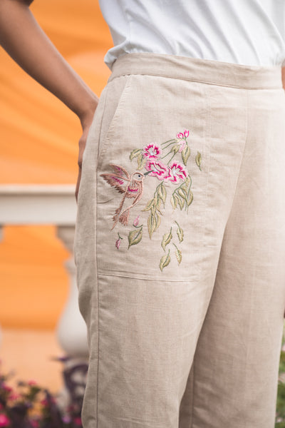 Isnt chilling more fun in these pants Beautiful white cigarette pants  with classy floral hand